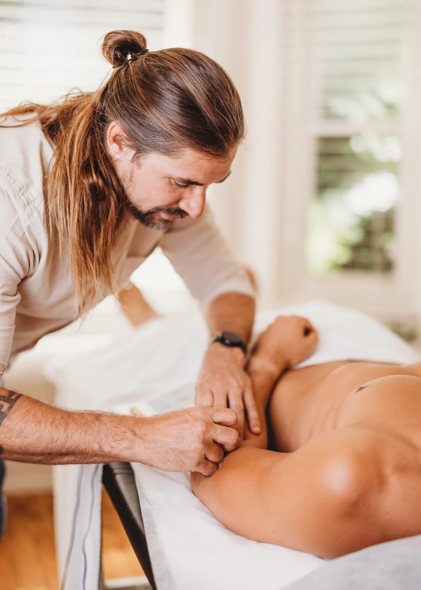 Dr. Truth Robinson performing trigger point needling dry needling at Ascend Acupuncture Byron Bay