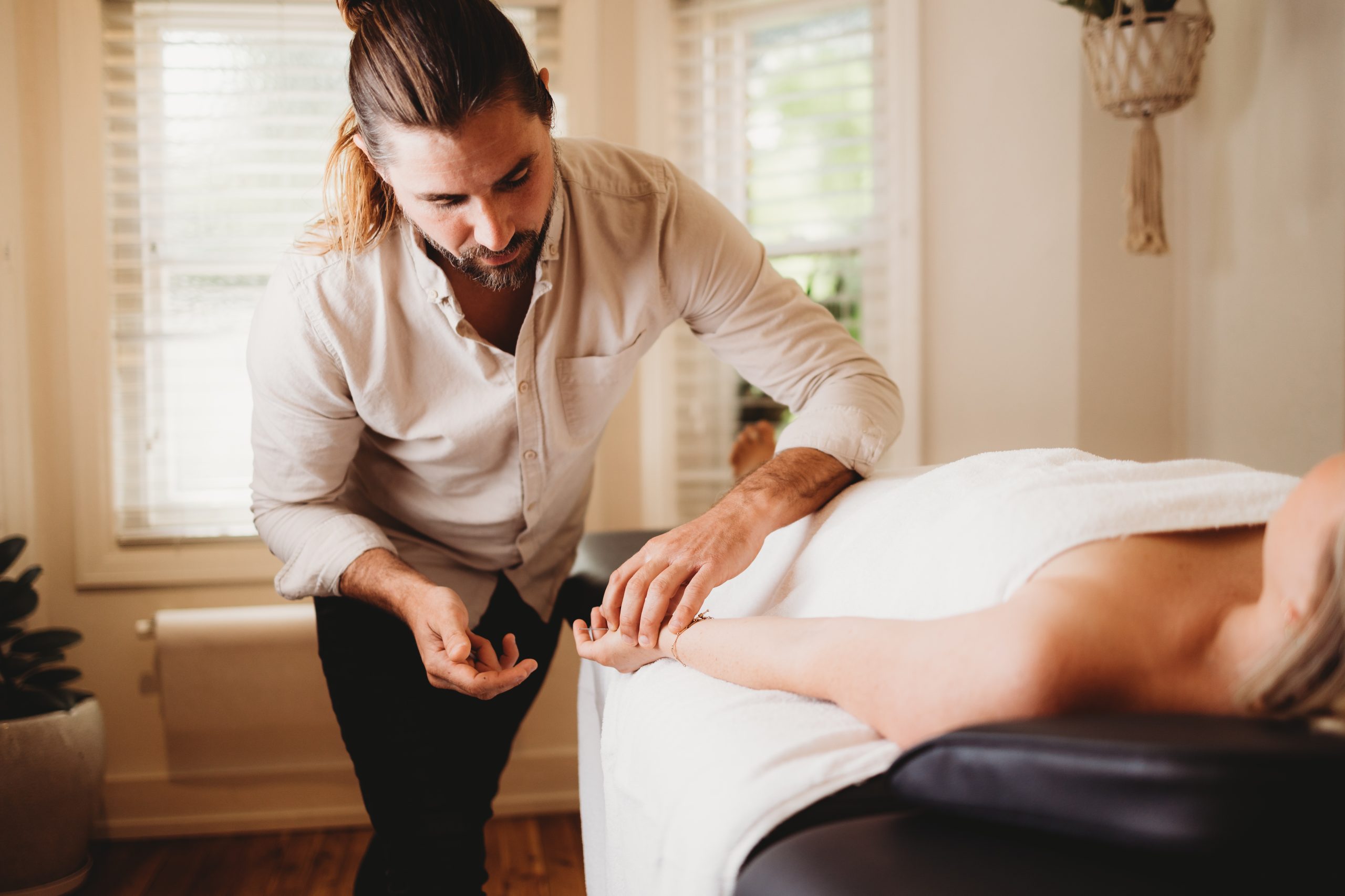 Dr. Truth Robinson performing acupuncture treatment at Ascend Acupuncture Byron Bay